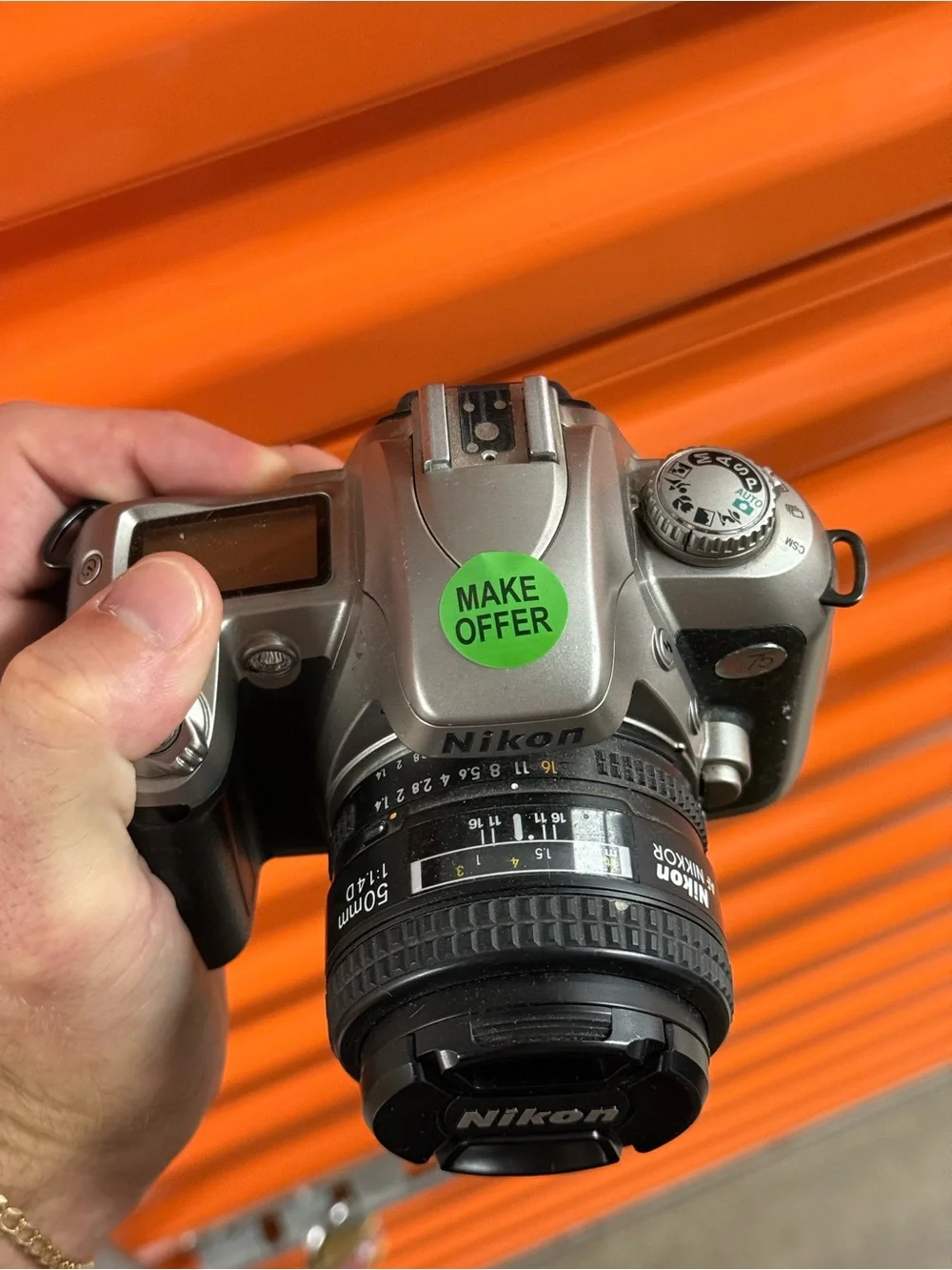 Nikon Silver and Black DSLR Camera with Nikon Lens Cap